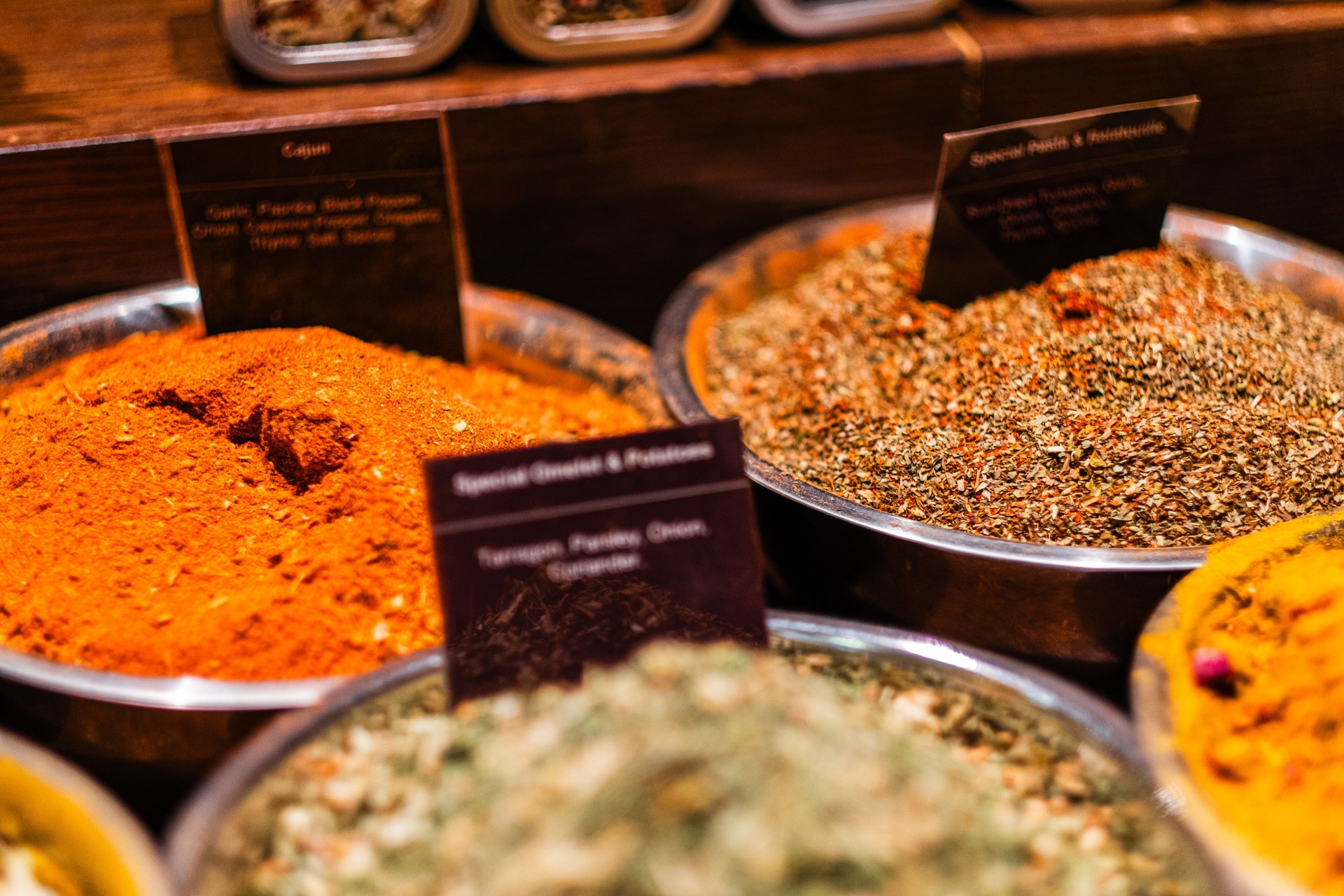 Variety of Colorful Spices and Herbs in Metal Bowls at a Market Displaying Cajun and Special Blends for Culinary Inspiration and Gourmet Cooking